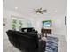 Bright living room with large windows, neutral decor, comfortable furniture, and stylish rug atop marble floors at 5006 W Idaho St, Tampa, FL 33616
