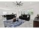 Bright living room with large windows, neutral decor, comfortable furniture, and stylish rug atop marble floors at 5006 W Idaho St, Tampa, FL 33616