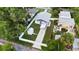An aerial shot of the property, highlighting the home, fenced backyard, and surrounding trees at 5055 9Th St, Zephyrhills, FL 33542