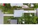 Aerial view of the home showing the roof, driveway, and landscaping of the property at 5055 9Th St, Zephyrhills, FL 33542