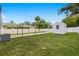 Backyard featuring covered parking, storage shed, privacy fence, and a well maintained lawn at 5055 9Th St, Zephyrhills, FL 33542