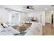 Spacious living room features hardwood floors, modern furniture, and lots of natural light at 5055 9Th St, Zephyrhills, FL 33542