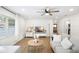 Bright living room featuring a ceiling fan, hardwood floors, and comfortable modern furniture at 5055 9Th St, Zephyrhills, FL 33542