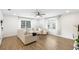Bright living room with modern furniture, hardwood floors, and natural light from large windows at 5055 9Th St, Zephyrhills, FL 33542