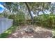 Fenced backyard featuring a fire pit, greenery, and a privacy fence at 512 Pinewalk Dr, Brandon, FL 33510