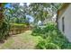 A cozy backyard including beautiful garden and privacy fence at 512 Pinewalk Dr, Brandon, FL 33510