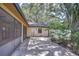Backyard patio featuring a screened-in porch and a spacious outdoor area with mature trees at 512 Pinewalk Dr, Brandon, FL 33510