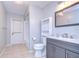 Bright bathroom features neutral tile floors, gray vanity, and shower/tub combo at 512 Pinewalk Dr, Brandon, FL 33510