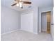 Bedroom with carpet, a ceiling fan, a closet, and access to another room at 512 Pinewalk Dr, Brandon, FL 33510
