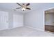 Neutral bedroom with carpet, ceiling fan, and closet with bi-fold doors at 512 Pinewalk Dr, Brandon, FL 33510