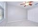 Bedroom features include carpet, ceiling fan, a large window and a closet at 512 Pinewalk Dr, Brandon, FL 33510