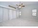 Spacious bedroom featuring vaulted ceilings, large windows with curtains, and a ceiling fan at 512 Pinewalk Dr, Brandon, FL 33510