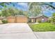 Charming home with a three car garage and well-manicured lawn at 512 Pinewalk Dr, Brandon, FL 33510