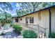 Home exterior with a light yellow paint, wood railings, and bushes at 512 Pinewalk Dr, Brandon, FL 33510