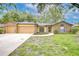 Charming single-story home with brick accents, well-maintained landscaping, and attached two-car garage at 512 Pinewalk Dr, Brandon, FL 33510