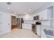 Bright kitchen with white cabinetry, granite countertops, stainless steel appliances, and tile flooring at 512 Pinewalk Dr, Brandon, FL 33510