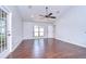 Open-concept living room with hardwood floors, a ceiling fan, and a large window at 512 Pinewalk Dr, Brandon, FL 33510