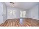 Open living room featuring beautiful wood floors, and large windows allowing natural light at 512 Pinewalk Dr, Brandon, FL 33510