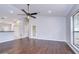 Open-concept living room with hardwood floors, a ceiling fan, and a white door with glass at 512 Pinewalk Dr, Brandon, FL 33510