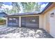 Outdoor patio with stone flooring, screened walls, and dark trim at 512 Pinewalk Dr, Brandon, FL 33510