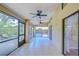 Screened-in porch featuring tiled floors, ceiling fans, and sliding glass windows at 512 Pinewalk Dr, Brandon, FL 33510