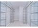 Spacious walk-in closet with metal shelving offering ample storage, and light carpet at 512 Pinewalk Dr, Brandon, FL 33510