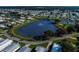 An aerial view of the community features a peaceful lake and neatly arranged homes at 5706 Benton St, Zephyrhills, FL 33542