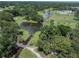 An aerial shot shows a golf course and pond that add beauty to this community at 5706 Benton St, Zephyrhills, FL 33542