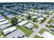 An aerial view showcasing a well-maintained neighborhood with manicured lawns and mature trees at 5706 Benton St, Zephyrhills, FL 33542