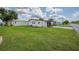 Exterior view of house with well-maintained lawn, showcasing its neat appearance and inviting curb appeal at 5706 Benton St, Zephyrhills, FL 33542