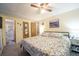 Comfortable main bedroom with ensuite bathroom and neutral decor and flooring at 5706 Benton St, Zephyrhills, FL 33542