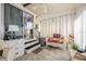 Well-lit sunroom featuring neutral tones, tile flooring, wicker furniture, and a view of the outdoors, perfect for relaxation at 5706 Benton St, Zephyrhills, FL 33542