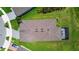 Overhead view of a single-Gathering home showcasing the roof, driveway, and lush green surroundings at 6211 Sea Air Dr, Apollo Beach, FL 33572