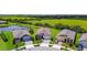 Aerial view of homes with manicured lawns next to a large field with scattered trees and surrounded by paved neighborhood streets at 6211 Sea Air Dr, Apollo Beach, FL 33572