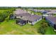 Beautiful backyard featuring a screened patio, well-maintained lawn, and partial view of the home's exterior at 6211 Sea Air Dr, Apollo Beach, FL 33572