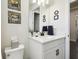 Clean bathroom with a white vanity, black fixtures, and neutral decor at 6211 Sea Air Dr, Apollo Beach, FL 33572