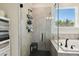Modern bathroom highlighting a glass-enclosed shower, soaking tub, and stylish tile work at 6211 Sea Air Dr, Apollo Beach, FL 33572