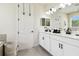 Bathroom with double sinks, quartz countertop and dark hardware at 6211 Sea Air Dr, Apollo Beach, FL 33572