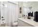 Bright bathroom featuring a tub, white tile surround, and a modern vanity with black fixtures at 6211 Sea Air Dr, Apollo Beach, FL 33572