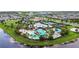 Community amenities with pools, recreational courts, clubhouse amidst lush landscaping and lake view at 6211 Sea Air Dr, Apollo Beach, FL 33572