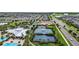 Aerial view of community tennis courts and recreational areas amidst a residential neighborhood with green landscaping at 6211 Sea Air Dr, Apollo Beach, FL 33572