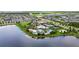 Community amenities with pools, recreational courts, clubhouse amidst lush landscaping and lake view at 6211 Sea Air Dr, Apollo Beach, FL 33572