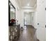 Inviting foyer with decorative table, tray ceiling, and wood-look tile flooring at 6211 Sea Air Dr, Apollo Beach, FL 33572