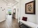 Bright foyer with tile flooring, bench, and a view of the living spaces beyond at 6211 Sea Air Dr, Apollo Beach, FL 33572