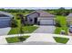 Beautiful front of house with gray stone details, well manicured lawn, and brick driveway at 6211 Sea Air Dr, Apollo Beach, FL 33572