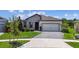 Attractive home with a stone accent, manicured lawn, and a paved driveway leading to a spacious two-car garage at 6211 Sea Air Dr, Apollo Beach, FL 33572