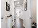 Bright hallway boasts modern tile floors, white walls, and tasteful artwork at 6211 Sea Air Dr, Apollo Beach, FL 33572