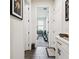 Hallway leading to a living area with white trim and luxury vinyl plank flooring at 6211 Sea Air Dr, Apollo Beach, FL 33572