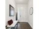 Entryway hallway featuring tile floors, white wainscoting, a white bench and attractive decor at 6211 Sea Air Dr, Apollo Beach, FL 33572