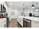 Modern kitchen features a spacious island with a sink, dishwasher, and stainless steel appliances at 6211 Sea Air Dr, Apollo Beach, FL 33572